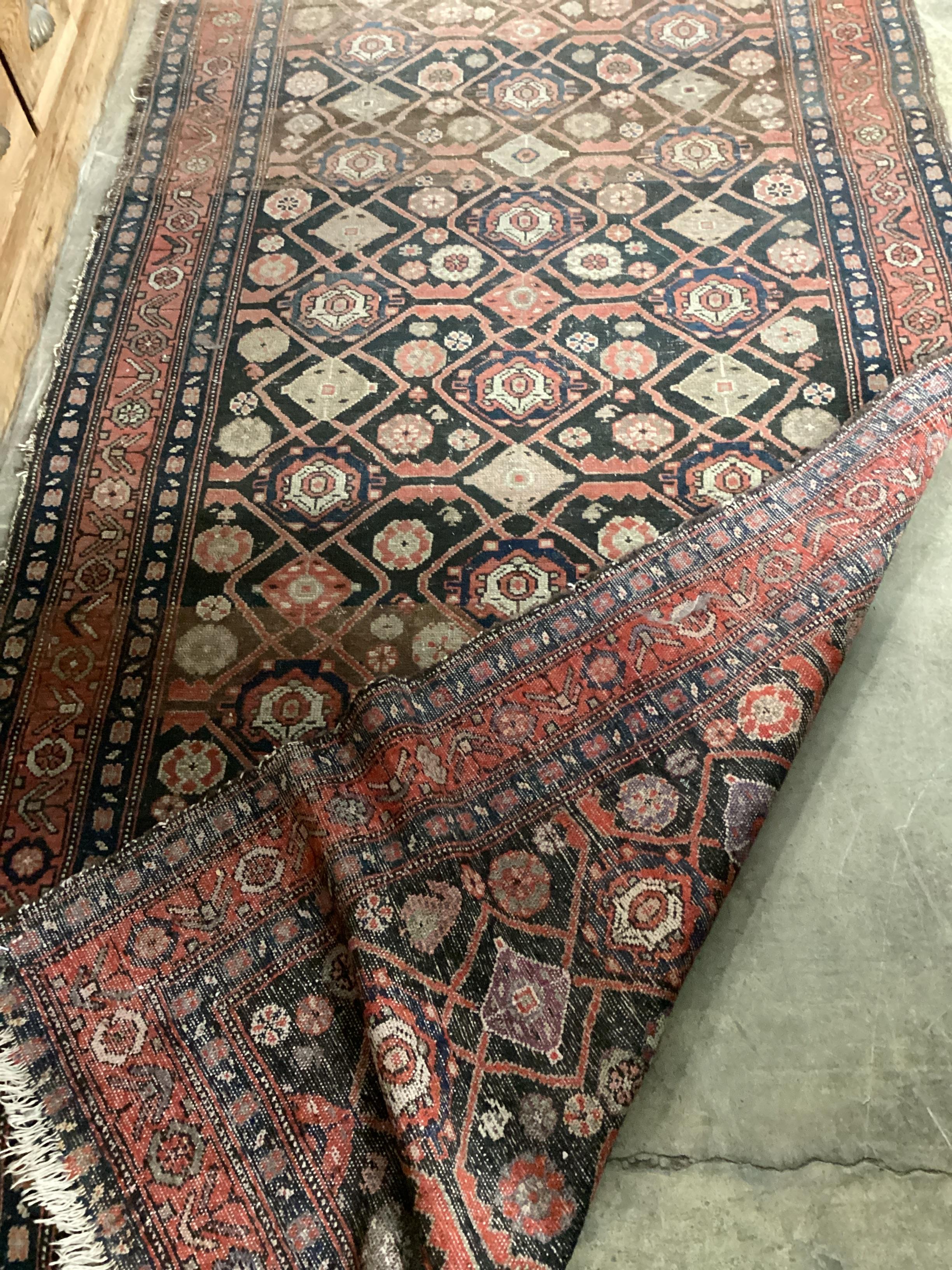 An antique Hamadan blue ground rug, 270cm x 120cm